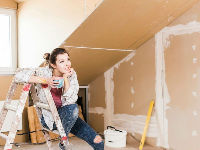 young-woman-contemplating-the-renovation-of-her-new-home.jpg